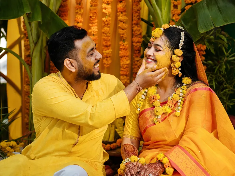 Gaye holud ceremony in Chittagong - Bangladeshi couple in yellow attire with marigold flower jewelry and mehndi - Tasnim and Rahul's success story